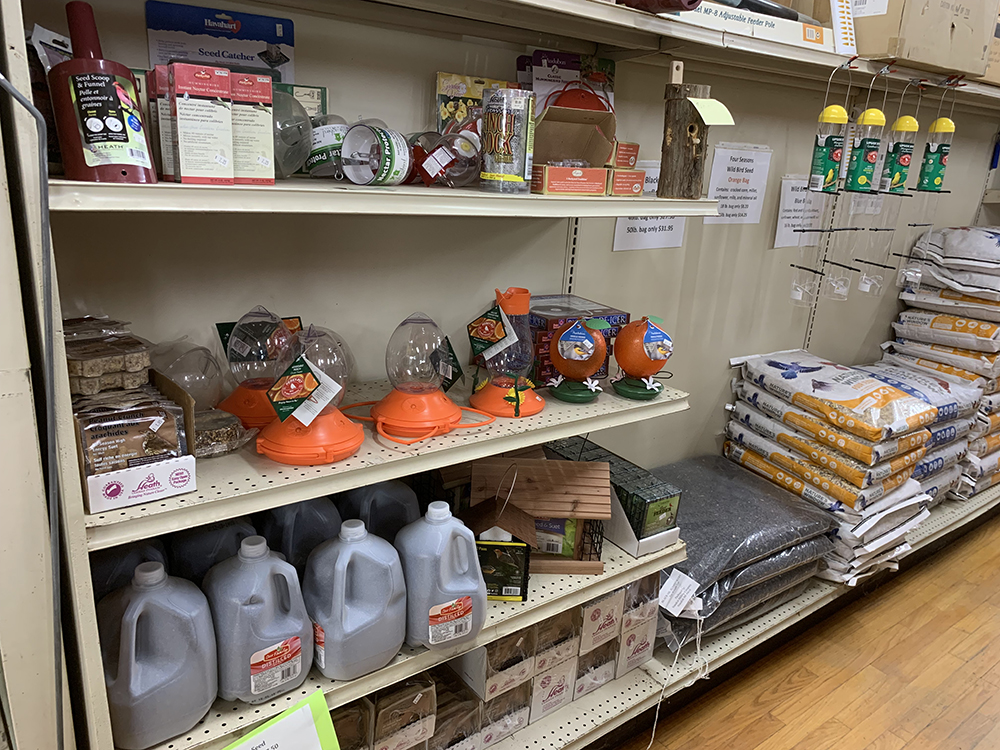 bird seed feeders in a shelf