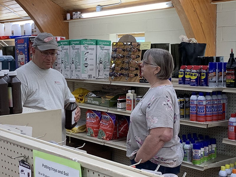 A woman talking to another person looking at products